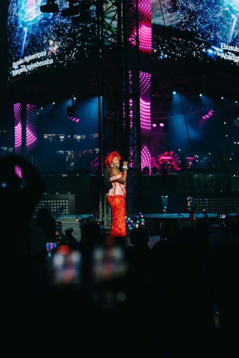 Vocalist performing under red stage light